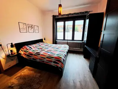 a bedroom with a bed and a window at Chambre dans une maison d'hote in Liège