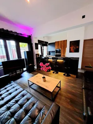 a living room with a couch and a coffee table at Chambre dans une maison d'hote in Liège