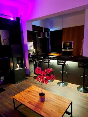 a room with a table with a vase of flowers on it at Chambre dans une maison d'hote in Liège