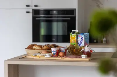 a table with a tray of food on a counter at NIEUW - De Grenspaal WEST 6P 5 min Maastricht - Sauna - Laadpaal in Riemst