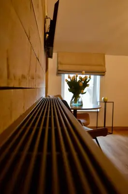 a bed in a room with a table and a window at Hoeve de Sterappel in Tongeren