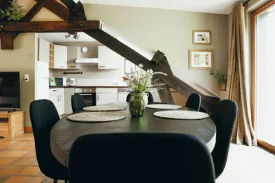 a dining room with a table and chairs at La Terrasse du Pré by WelcHome in Verviers