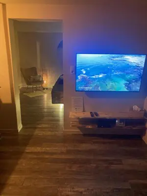 a living room with a large flat screen tv at Au coeur du 11 in Beyne-Heusay