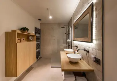 a bathroom with two sinks and a mirror at Vakantiewoning 'De Teut' in Zonhoven