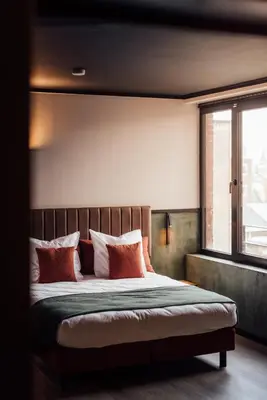 a bedroom with a large bed with red pillows at Getaway Liège in Liège