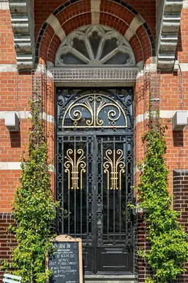 a black door on the side of a brick building at Hof van In & Wellness in Hasselt