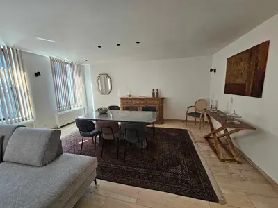 a living room with a table and a couch at Stadsparel Sint-Truiden in Sint-Truiden