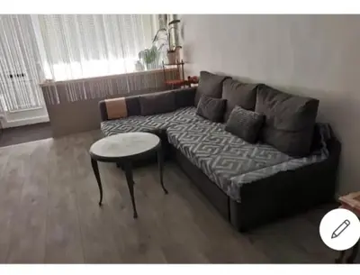 a living room with a couch and a table at Vintage house ViVa in Leopoldsburg