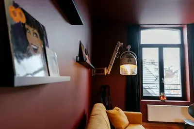 a living room with a couch and a window at Le rétro chic - Grand Duplex pour 6 dans le centre in Liège