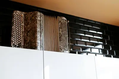 a stack of books sitting on top of a white cabinet at Le rétro chic - Grand Duplex pour 6 dans le centre in Liège