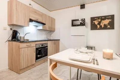 a kitchen with a table and a counter top at Le Quai #7 - Calme et Confort près de Liège in Liège