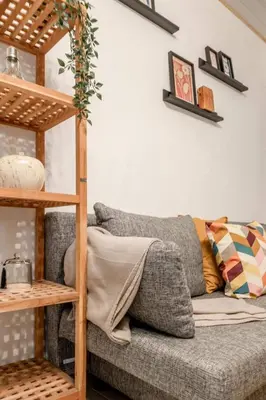 a living room with a couch and a shelf at Le Quai #7 - Calme et Confort près de Liège in Liège