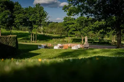 a garden with chairs and tables in the grass at Vakantiewoningen Hoeve Carpe Diem - Dalhem - Aubel - Voeren in Dalhem