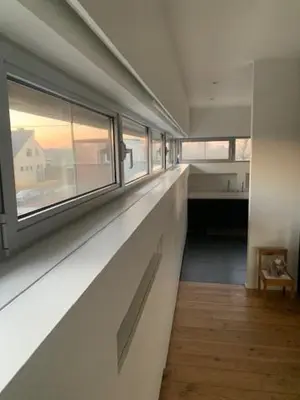 a long hallway with a window in a house at 't Veldje in Tongeren