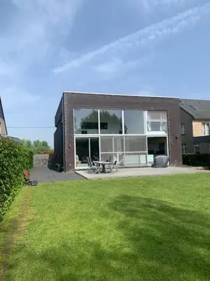 a house with a large window on a lawn at 't Veldje in Tongeren