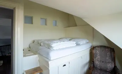 a bed sitting on top of a cabinet in a room at Maas Suites - The French House in Lanaken