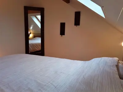 a bedroom with a white bed and a mirror at Point Escale in Lontzen