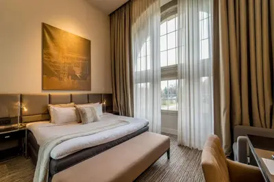 a hotel room with a bed and a window at Terhills Hotel in Maasmechelen