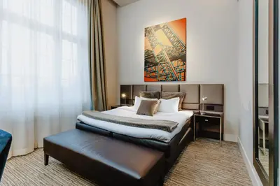 a hotel room with a bed and a large window at Terhills Hotel in Maasmechelen