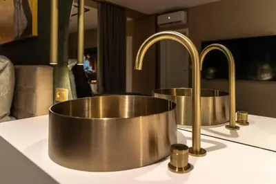 two copper faucets on a kitchen counter at SuiteDreams - Bali Suite Liège in Liège