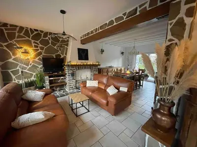 a living room with leather furniture and a fireplace at Happiness at Lili in Verviers