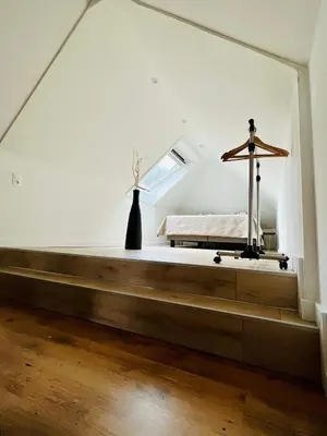 a bedroom with a bed in a white room at Maison Isa in Lommel