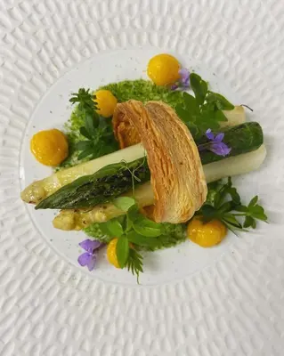 a plate of food with vegetables on a plate at Lafarques in Pepinster