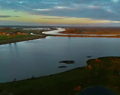 an aerial view of a river with rocks in the water at Guesthouse De Wissen in Dilsen-Stokkem