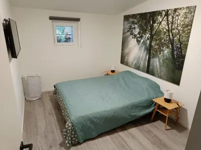 a bedroom with a bed and a painting on the wall at Gusta in Maasmechelen