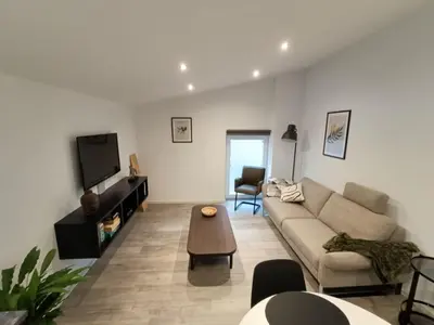 a living room with a couch and a table at Gusta in Maasmechelen