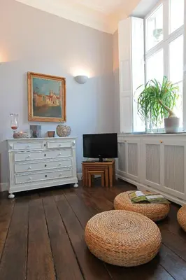 a living room with a white dresser and a television at Le Dragon Limbourg - Luxurious & Cozy Holiday Home in Limbourg
