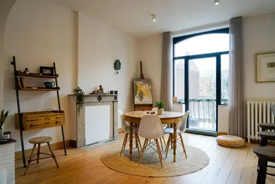 a living room with a table and a fireplace at LOFT 44 - thuis in Hasselt in Hasselt