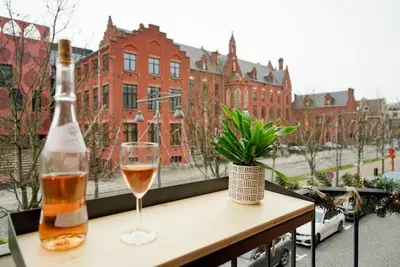 a bottle of wine and a glass on a table at LOFT 44 - thuis in Hasselt in Hasselt