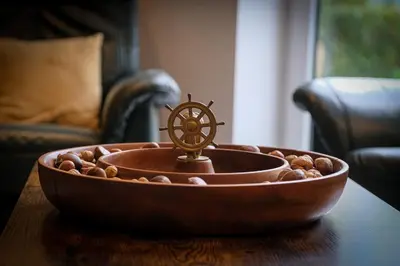 a wooden bowl with a wheel on top of a table at Gîte La Vieille Ferme Chaudfontaine et son jacuzzi in Chaudfontaine