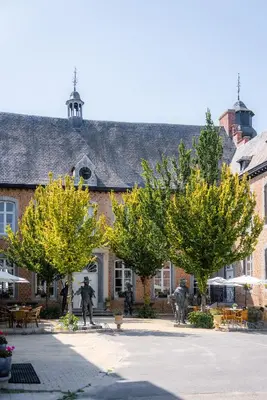 two fire fighters standing in front of a building at Château de Looz in Borgloon