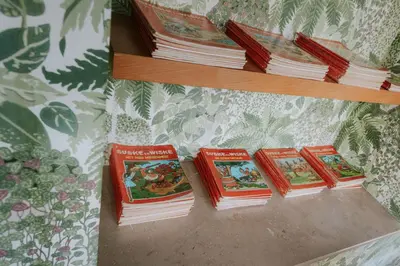 a group of books sitting on a shelf at Château de Looz in Borgloon
