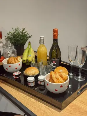 a tray with bowls of food and glasses of wine at LCforyou in Juprelle