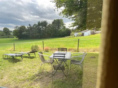 a picnic table and chairs in a field at WalHOME: Hohes Venn, 3 Grenzen, Natur in Walhorn
