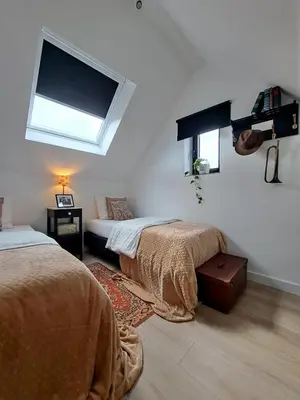 a bedroom with two beds and a window at Hotel Apartments Belgium 5 - HAB 5 in Balen