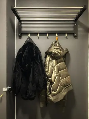 a pair of jackets hanging on a wall at Suite luxueuse aux Guillemins in Liège