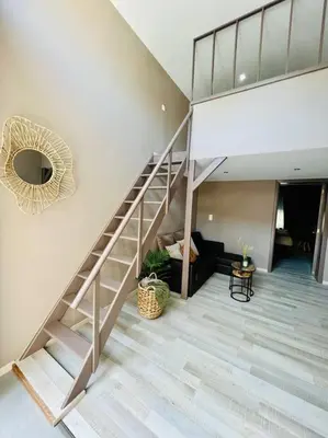 a staircase in a living room with a stair case at Appartement tropical in Liège