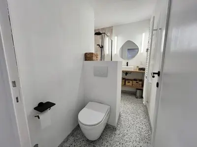 a white bathroom with a toilet and a sink at Havre des Anges - Pont de Fragnée, Guillemins in Liège