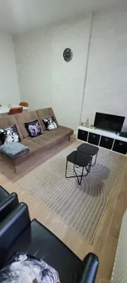 a living room with a couch and a table at Au pied du théâtre in Verviers