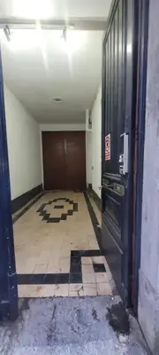 an empty room with a door and a tile floor at Au pied du théâtre in Verviers