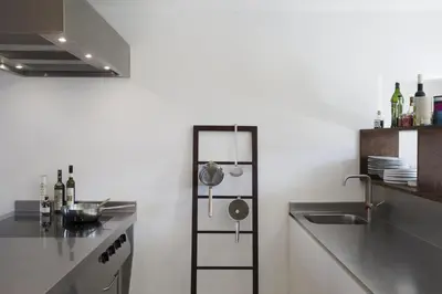 a kitchen with a sink and a stove and a counter at B&B Opus35 in Montzen