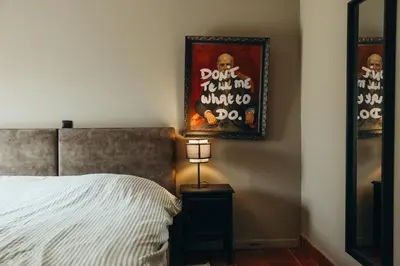 a bedroom with a bed and a picture on the wall at Au pied du Pré by WelcHome in Verviers
