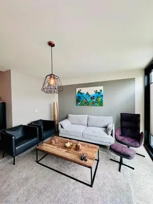 a living room with a couch and a coffee table at Stylish Home near Maastricht Alicias house in Lanaken