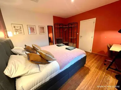 a bedroom with a bed with pillows on it at Le Loft liégeois - Au coeur de la cité in Liège