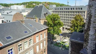 an overhead view of a city with buildings and trees at Amosa Liège City Centre Hotel in Liège