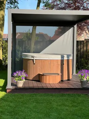 a covered area with two potted plants on a deck at Maison Idyllique in Bree